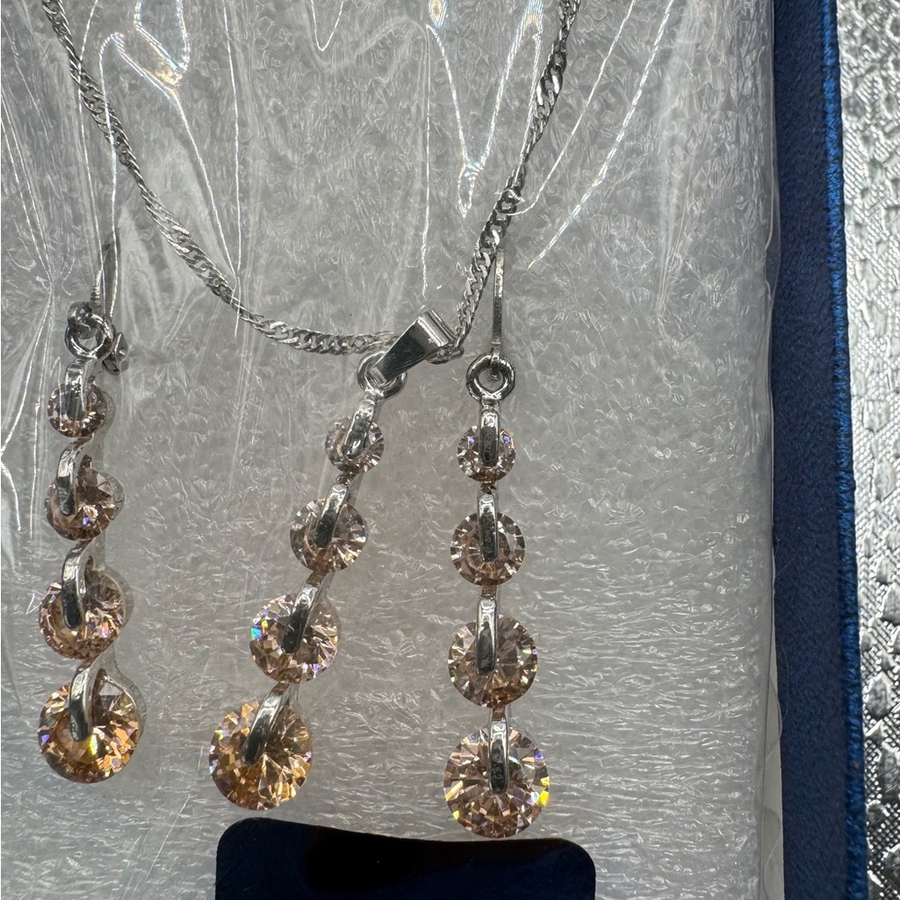 silver-toned necklace three-stone pendant matching three-stone dangle earrings